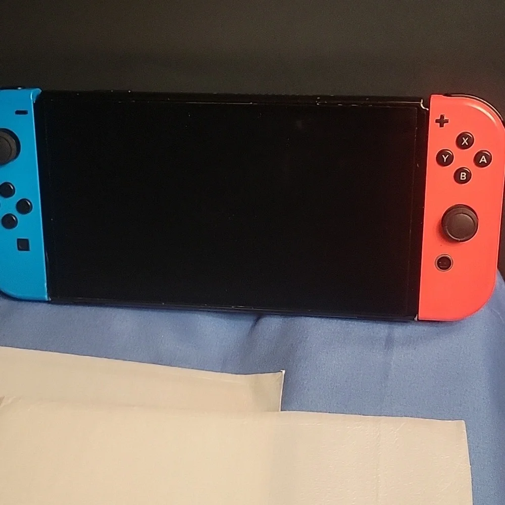 Nintendo Switch OLED with Neon Blue and Red Joy-Con Controllers.